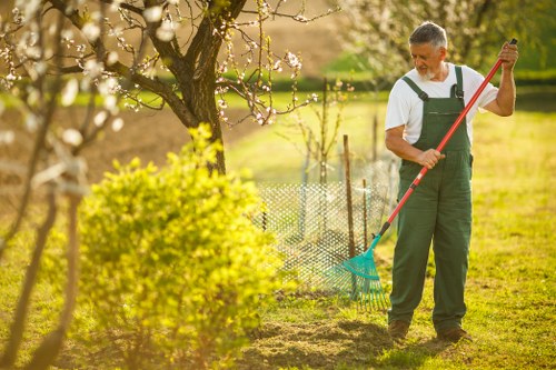 Operative measuring a garden pile for cubic-yard estimation